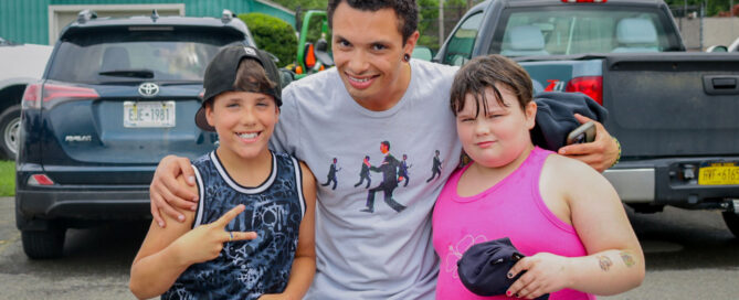 Children's Home member smiles with two kids